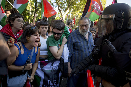 Pro-Palestinian protesters shouts at a police officer during the pro-Palestinian demonstrations while the 21st stage of the Cycling Tour of Spain was canceled. The 90th edition of the Cycling Tour of Spain was marked by protests in support of the Palestinian people.