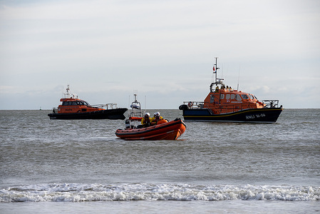 The RNLI boats are near the seashore to prevent and save swimmers during the New Year's Day Dip event in Ramsgate. The Ramsgate New Year's Day Dip started in 2013 by John Brown and Vicki Boyle to raise money for Ronald McDonald Houses, in memory of their son Joseph who passed away in 2012. Around 200 people gathered at midday at the Ramsgate Beach to attend the Ramsgate New Year's Day Dip.