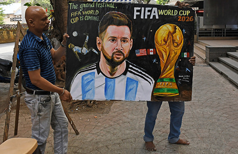 Teachers from Gurukul school of art carry back a painted poster of Argentine football player Lionel Messi with a message welcoming the FIFA World Cup 2026 outside their art school in Mumbai. The 23rd edition of FIFA World Cup 2026 features 48 teams taking place in three countries and hosted across 16 cities uniting the fans across the globe through football.