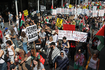 Protesters march with placards expressing their opinion along the streets during the demonstration. Pro-Palestine demonstrators, some coming from major East Coast cities, marched in Manhattan, New York City, to denounce the genocide in Palestine and the killing of journalists in Gaza.