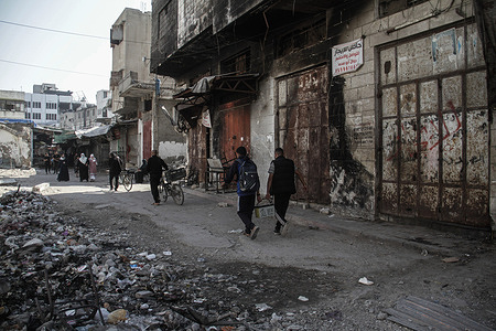 Palestinians walk at Al-Zaya market in Gaza City. All markets in Gaza City are closed due to high prices and lack of goods.