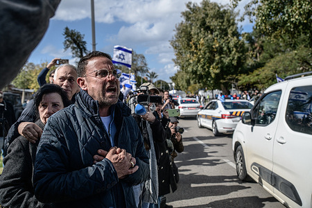 Israeli citizens salute while shouting “We’re sorry!” as the bodies of Israeli hostages Shiri Bibas, Kfir Bibas, Ariel Bibas and Oded Lifshitz arrive for identification in Abu Kabir Forensic Institute. Israelis gathered in front of Abu Kabir Forensic Institute to show their respect to deceased Israeli hostages Shiri Bibas, Kfir Bibas, Ariel Bibas and Oded Lifshitz.