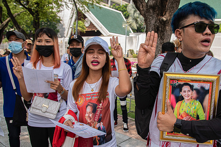 Protesters hold portraits of Aung San Suu Kyi and make three finger during the demonstration in front of the United Nations building in Bangkok. Burmese workers in Thailand gathered in front of the United Nations building to protest against the Myanmar military government following its orders to all Burmese workers abroad to remit at least 25 percent of their foreign currency income to the country's banking system.