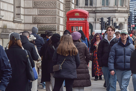 Tourists queue up to take selfies next to a popular red telephone box near Big Ben in Parliament Square. The government is set to allow local authorities, including the Mayor of London, to impose a modest tourist tax for overnight stays.