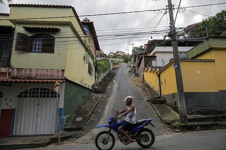 A motorbike drives along a street in the Senhor dos Montes neighborhood. São João del Rei, one of the colonial cities of Minas Gerais in Brazil, was founded during the 18th-century gold rush and later became an important regional center in the Portuguese colony.