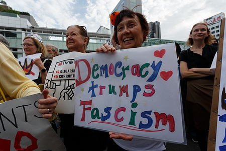People hold signs and chant during the "No Tyrants" protest. The protest organised by Democrats abroad included around 200 American experts, visitors and Japanese and was part of the "No Kings" protests against President Trump of the United States that took place globally on October 18th.
