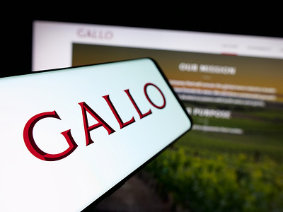In this photo illustration, a smartphone with the logo of US wine producing company E. J. Gallo Winery is seen on screen in front of website.