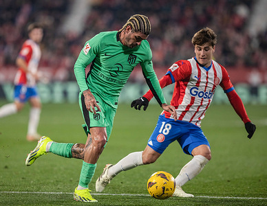 De Paul (L) of Atlético de Madrid and Pablo Torre (R) of Girona F.C seen in action during the LALIGA EA SPORT match between Girona F.C and Atlético de Madrid at Estadi Montilivi. Final score; Girona 4:3 Atlético de Madrid.