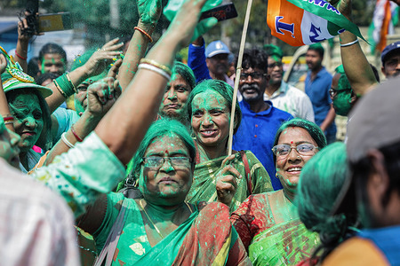 Women supporters of TMCP (Trinamool Congress party) seen covered in green coloured powder while celebrating their victory in the municipal corporation election.