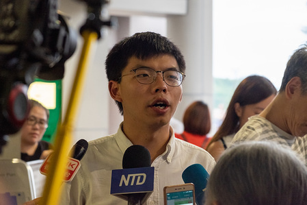 Secretary-general of pro-democracy party Demosistō, Joshua Wong Chi-fung speaks to the media after being released on bail outside the Eastern Law Court building in Hong Kong.
The two pro-democracy activists were arrested earlier in the day on charges of inciting others to participate in unauthorised gatherings.