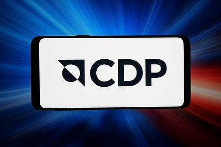 In this photo illustration, the logo of organisation CDP (Carbon Disclosure Project) is displayed on a smartphone in front of abstract background on computer screen.