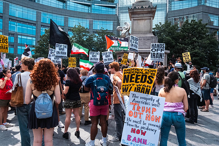 Demonstrators gather with placards after marching from Times Square to Columbus Circle during the protest. Anti-war protesters gathered in Times Square, in the wake of the news of US strikes on 3 nuclear sites in Iran.