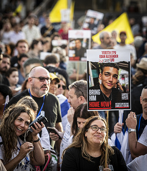 An Israeli woman holds a placard with a picture of released hostage Idan Alexander at hostages square. Hundreds of people gathered at Hostages Square to watch a live feed of the release of Edan Alexander, the last known living American hostage in Gaza. The 21-year-old was freed by Hamas and reunited with his family on Monday ending an 18-month ordeal that began with the militant group in the October 7 attack. His release came after several days of indirect negotiations between Hamas and the United States bypassing Israel as part of broader efforts to reach a ceasefire and restore humanitarian aid in Gaza.