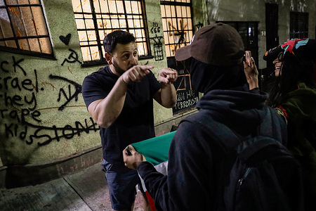 Pro-Palestinian protesters confront a supporter of Amir Fattal, an openly Zionist Israeli graphic artist during a demonstration. A demonstration is held in rejection of the Israeli army's actions in Palestine, which have led to the near extermination of its population since October 7, 2023. They later spray-painted the facade of the private KÖNIG GALERIE gallery, where he was exhibiting some of his AI-generated works.