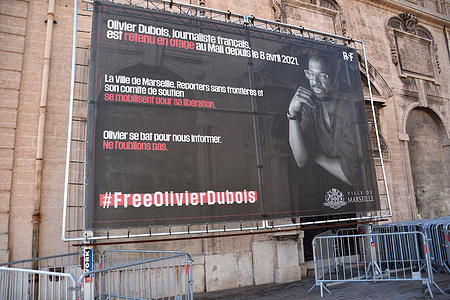 A banner in support of French journalist Olivier Dubois is seen on one of the facades of the town hall in Marseille. The town hall of Marseille displayed a banner in support of the French journalist Olivier Dubois held hostage in Mali since April 8, 2021.