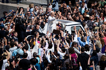 Pope Leo XIV greets the faithful at the end of the Easter Mass.