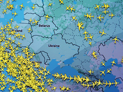 A map from flightradar24.com shows numerous yellow airplane icons, indicating air traffic avoiding the war zones in Ukraine.