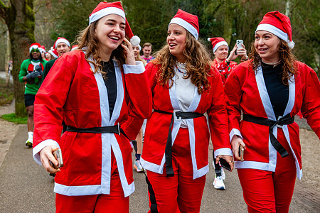 Three female runners are dressed as Papa Noel. Participants must wear their ugliest Christmas outfit to run this 5km race that goes through the Vondelpark in Amsterdam.