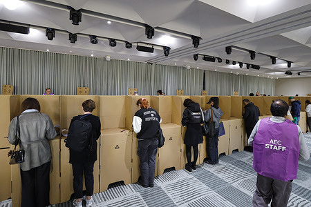 Voters mark their ballot papers in private booths on election day during the 2025 Australian federal election. On election day, 3 May 2025, voters in Melbourne’s inner-city electorate, the Division of Melbourne, cast their ballots at the Zinc voting center in Federation Square.