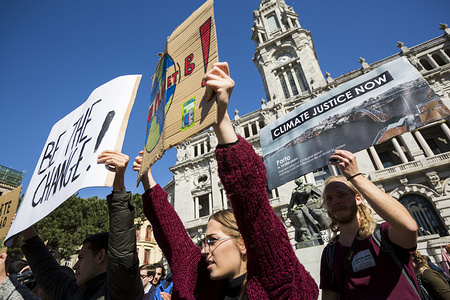 Students seen holding placards during the demonstration.
Students stage a protest against the World climate policies in front of Porto City Hall in Portugal.