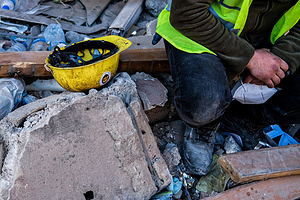 Hatay, Turkey - 14/02/2023 16:45:36: A man with a search and rescue helmet takes a break. Turkey and Syria have experienced the worst earthquakes to strike the region in almost a century. A 7.8-magnitude quake struck southeastern Turkey, which was followed by a second quake of 7.7 in northern Syria. More than 30,000 people are reported to have died due to the quakes, and the death toll is still rising.