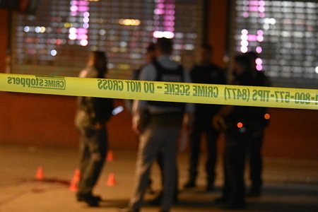 Police officers investigate Shooting at White Plains Road and Burke Avenue in Bronx. Two males were shot according to the New York City Police Department. One 17-year-old male was shot and is in stable condition and another male is in critical condition.