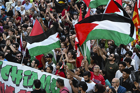 Protesters are seen waving Palestinian flags during the rally. Nearly 8000 people attended the national strike for Palestine in Piazza Loreto in Cosenza. The strike, involving about 80 cities, was called by Basic Trade Unions (USB) in support of the Palestinian cause and requesting the Governments’ commitment for ceasefire in Gaza.