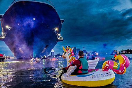 An activist is seen on a unicorn boat floating on the water during an attempt to block the cruise ship. Activists from Extinction Rebellion (XR) attempted to block the Celebrity Eclipse cruise ship from docking today but were unsuccessful. XR highlighted the ship’s significant environmental impact, including high carbon emissions, wastewater discharge, and contributions to air pollution and global warming. While some cruise lines are adopting cleaner fuels and improving water management, environmental groups argue these steps are not enough to address the growing footprint of the expanding global cruise industry.