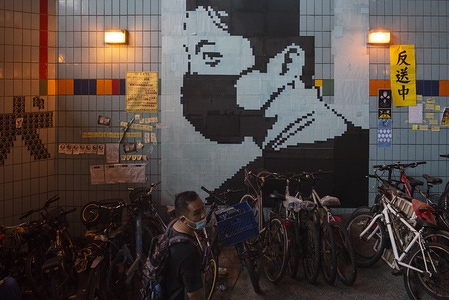 A protester walk past large a collage during the demostration. Anti-government protesters demostrate different aread of Hong Kong city which began in response to a proposed extradition law.