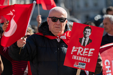 A protester holds a "Free Imamogul" placard during the demonstration. Supporters of Ekrem İmamoğlu, including backers of the Republican People's Party (CHP), gathered in Trafalgar Square to mark the first anniversary of his arrest and to protest in support of democracy in Turkey.