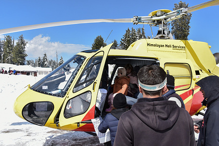Indian tourists board a helicopter for a sightseeing in Gulmarg, a world famous ski-resort, about 55kms from Srinagar, the summer capital of Jammu and Kashmir. The slopes of Gulmarg have once again started witnessing the exhilarating dance of heli-skiers as the Heli-Skiing services have returned to the ski resort after a hiatus of around four years.