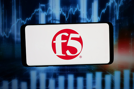 In this photo illustration, the logo of US technology company F5 Inc. is displayed on a smartphone in front of an abstract background on a computer screen.