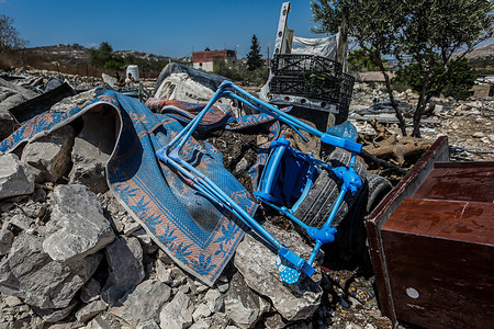 A view of the rubble of a collapsed building as people search the area for victims following an Israeli military operation in the village of Mirka.