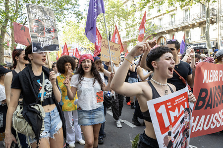 Protesters seen shouting slogans while holding placards, including one reading "IMPÉRIALISTES HORS DU MOYEN ORIENT," during the manifestation. Trade unions and political organizations in Paris gathered for the annual May Day manifestation to advocate for labor rights, social protection, and improved working conditions. The inter-union procession moving from Place de la République to Place de la Nation was marked by diverse social demands and a significant security presence in Paris on May 1, 2026.