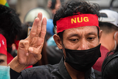 A protester makes a three finger salute while crying during the demonstration outside the Burmese embassy in Bangkok. Protesters gathered outside the Burmese embassy in Bangkok, Thailand to protest against the Burmese military after the Burmese Military's government executes 4 democracy activists including Kyaw Min Yu better known as Ko Jimmy and Myanmar rap pioneer Phyo Zeya Thaw.