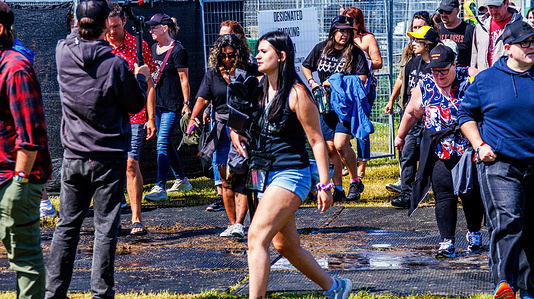 Fans return to the grounds following a severe storm that hammered the Rock'n Thunder festival grounds in Edmonton, just as show was about to start. Festival staff enacted evacuation protocols as storm with lightening, heavy rain and strong winds headed towards the festival grounds. Rockin' Thunder was able to continue after a 2 hours delay.