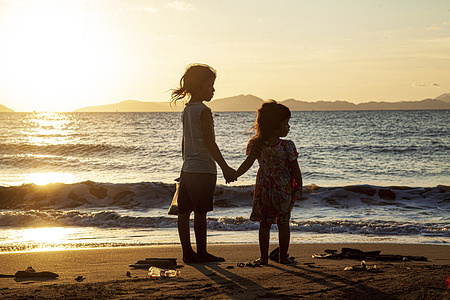 Two little girls are seen standing at Gampong Jawa beach.