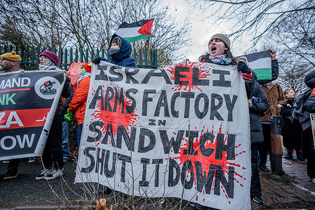 A protester chants slogans while holding a banner demanding that Elbit Systems be shut down by the UK Government, during a demonstration outside Woolwich Crown Court in London. Hundreds of pro-Palestinian protesters gathered as the first trial of the Filton 24 activists linked to "Palestine Action" reached its final day in court. At the same time, several defendants continued prolonged hunger strikes, with supporters warning that some had reached a critical, life-threatening condition while awaiting the court’s verdict.