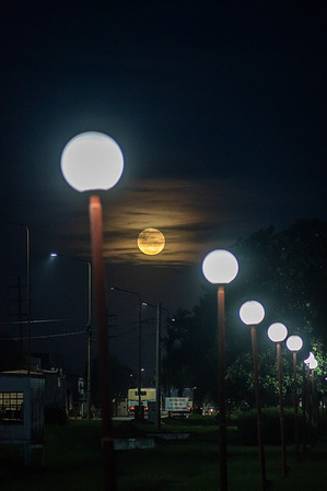 The last supermoon of the year, known as Cold Moon, is seen rising over a busy National Route 33 in Firmat.