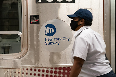 A woman wearing a face mask walks along the 34th Hudson Yards Station as MTA announces $50 Fine for people who are refusing to wear a face mask on public transit.