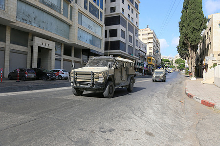 Israeli military vehicles withdraw from the scene of the military operation after surrounding a building in the Rafidia neighborhood of Nablus in the West Bank. Israeli forces conducted a military operation in the northern West Bank, arresting dozens of Palestinians, raiding institutions and organizations, and confiscating equipment, including computers and office files.