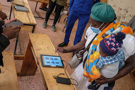 A voter uses a tablet to pick an aspirant during the Orange Democratic Movement (ODM) party nominations at Ayany Primary School in Nairobi's Kibera Slum. During the Kenyan political nominations, a handful of supporters showed up to nominate candidates of their choice and interest contesting for electoral positions from different political parties who will lead them through to the 9th August 2022 general elections should he or she qualify through the nominations.