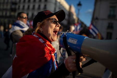 A woman shouts into a megaphone During a rally organized by Cuban exiles and residents in Madrid, called the "Caravan for the Freedom of Cuba," with simultaneous demonstrations in several countries. The demonstration was in support of the return of democracy to Cuba.