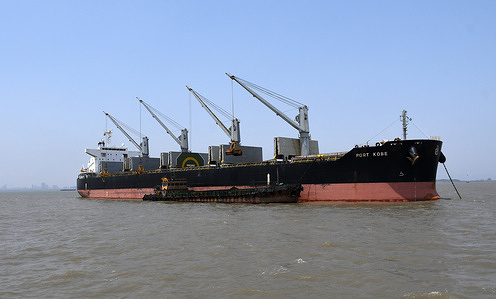 Port Kobe, a bulk carrier ship is seen emptying coal into small ship anchored next to it on Arabian sea near Mumbai port.
