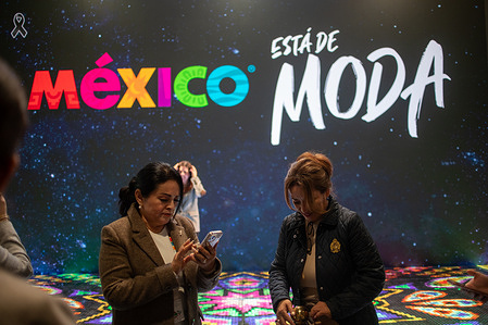 A group of people is seen in front of a slogan that reads "Mexico is in fashion" during the second day of the 46th edition of the International Tourism Fair (FITUR) 2026 in Madrid, in where Mexico participates as a partner country.