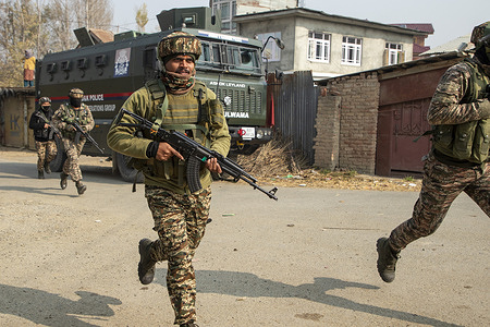 Special Operations Group personnel of Jammu and Kashmir police seen running towards a residential home during a cordon and search operation following a deadly car blast in Delhi that killed 13 people and injured dozens.
