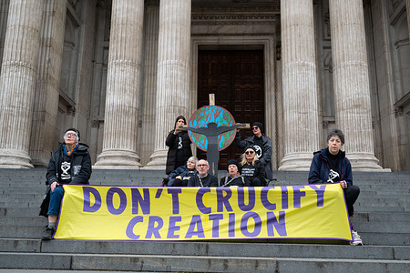 Protesters waiting for the security to start removing them from the premises. Members of Christian Climate Action staged a Good Friday protest outside St Paul’s Cathedral, calling for action against environmental destruction under the slogan “Don’t crucify creation.” Four protesters—James Grote, 69, a Baptist minister; Sue Parfit, 84, a Church of England priest; Sue Hampton, 69, a writer; and Deborah Wilde, 71, a retired teacher—chained themselves to a wooden cross before being carried away by cathedral security as the demonstration concluded.