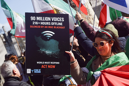 A protester holds a placard about the internet blackout in Iran during a demonstration outside Downing Street against the Islamic Republic and calling for Reza Pahlavi to take over as King of Iran, as the Iran war escalates.