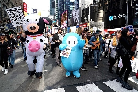 Protesters in New York City gather in Times Square for the "No Kings" March carrying signs and wearing costumes expressing their opinions protesting President Donald Trump and his administration's power over reach, lawlessness, and authoritarianism.