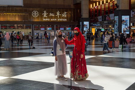 TAIPEI, TAIWAN - MAY 24, 2020: Muslim ladies posing for pictures while wearing face masks as a precaution at Taipei Main Station during the celebrations.
Eid Al-Fitr, which marks the end of Ramadan, the holy fasting month was celebrated amidst restrictions such as prohibited gatherings in public areas due to the coronavirus pandemic.
